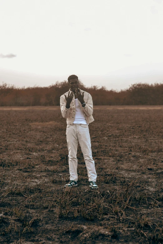 the person is taking a picture in a field