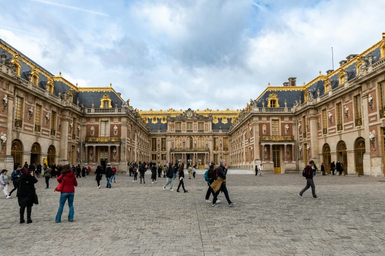 a courtyard is dotted with people walking about