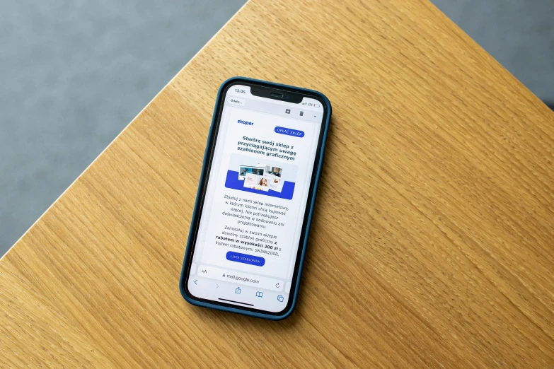 an iphone is sitting on a desk with a notepad