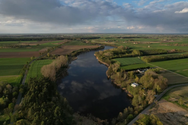 the aerial view of a large lake surrounded by countryside