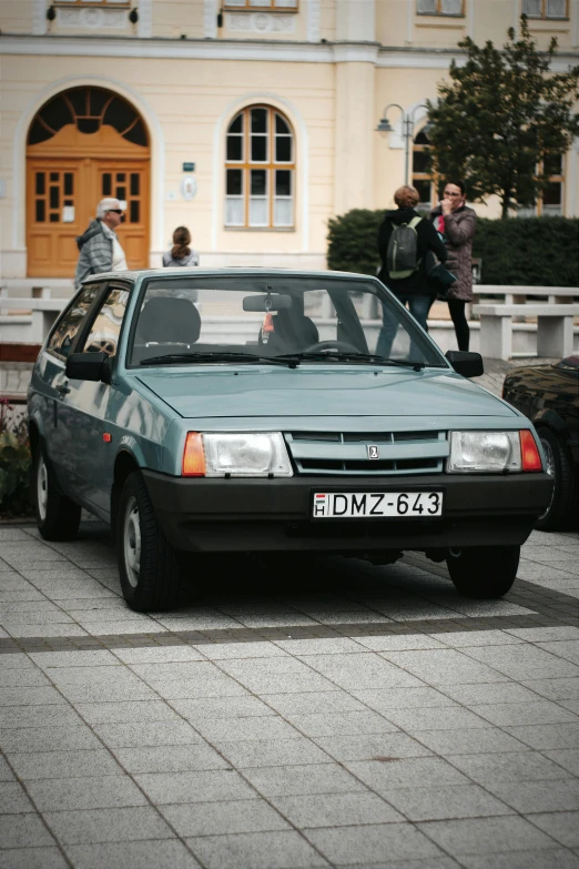 a man looking at a car with the hood open