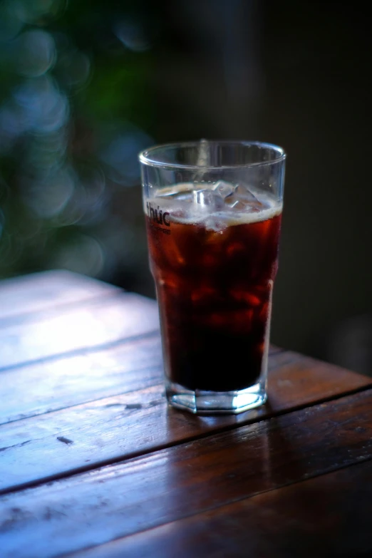a glass with an ice and coke