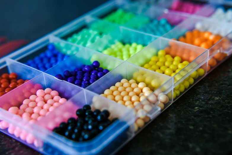 a group of small plastic containers of candy