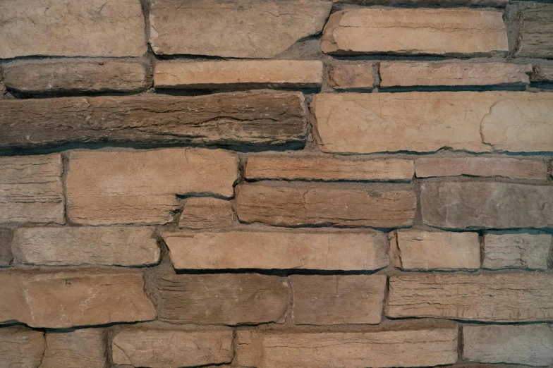 a stone wall made from various sized bricks