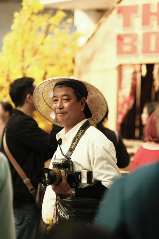 a young asian woman stands and smiles at the camera