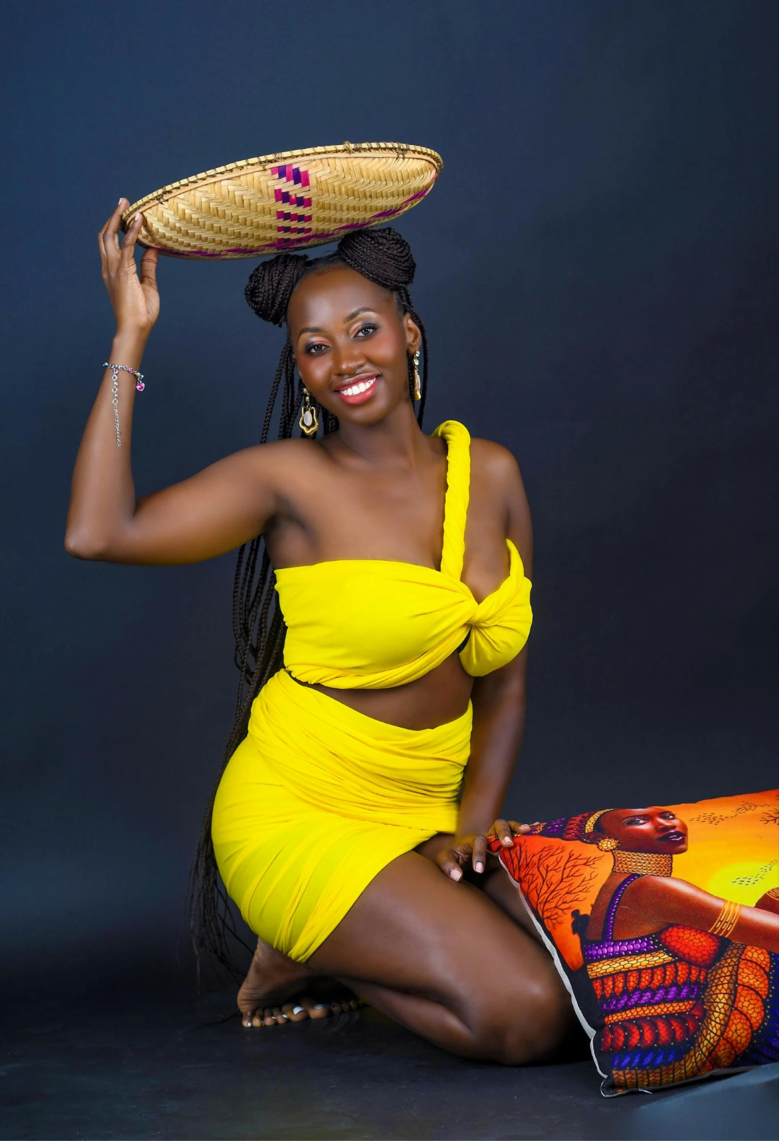 a woman in a yellow one piece dress and a straw hat poses for a po