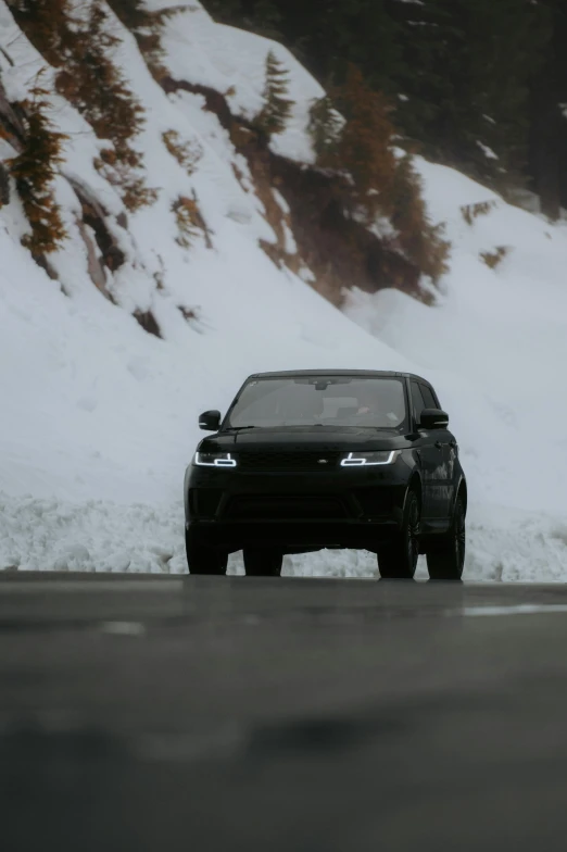 a vehicle is parked in front of a snow covered hill