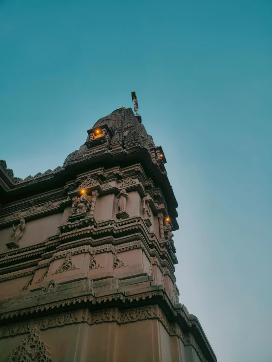 a tall tower with a weather vane on top of it