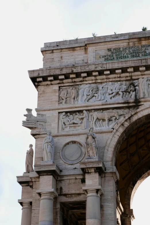 a stone arch with an archway and carvings on it