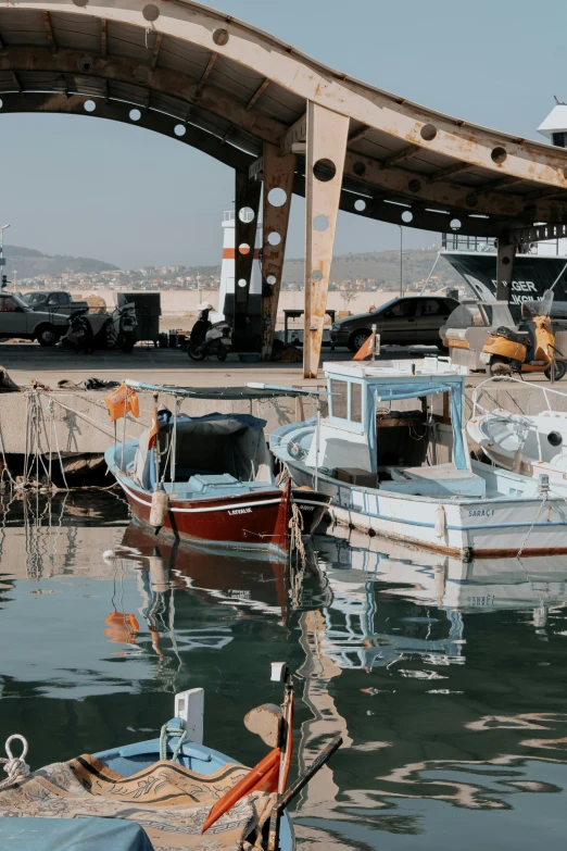 a bunch of boats in the harbor with some cars on them