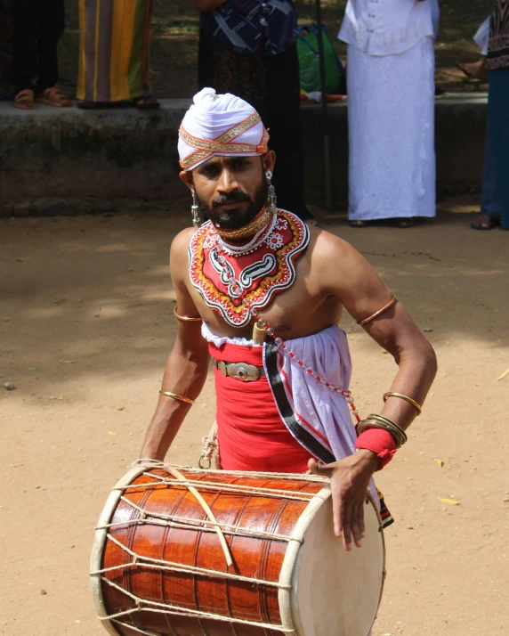 a man with his head covered and drums