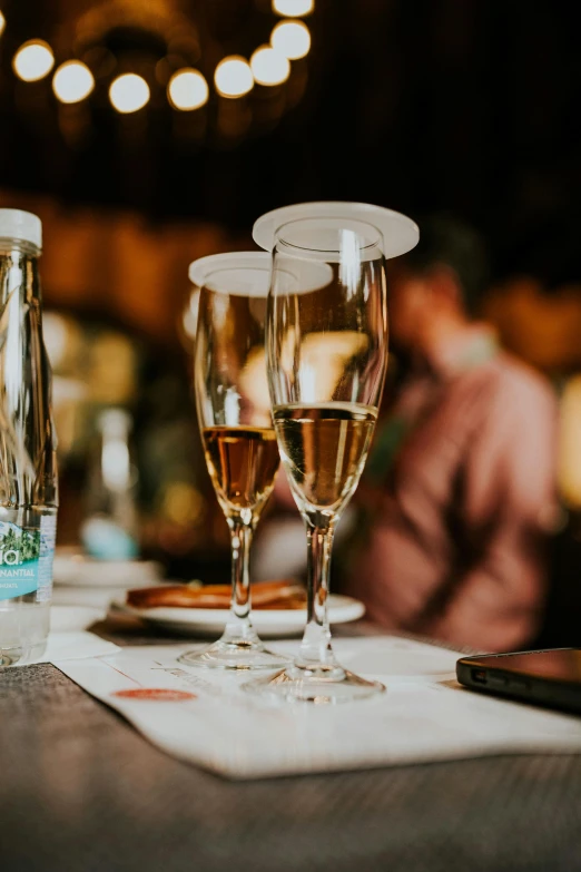 a table filled with two flutes and other glasses