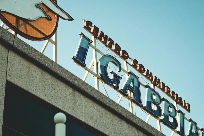 an outdoor sign on top of a building