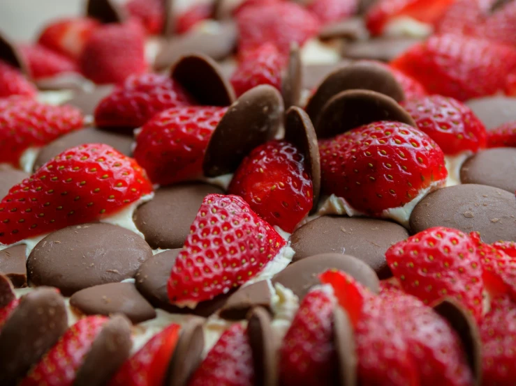 the chocolate is surrounded by strawberries and candy