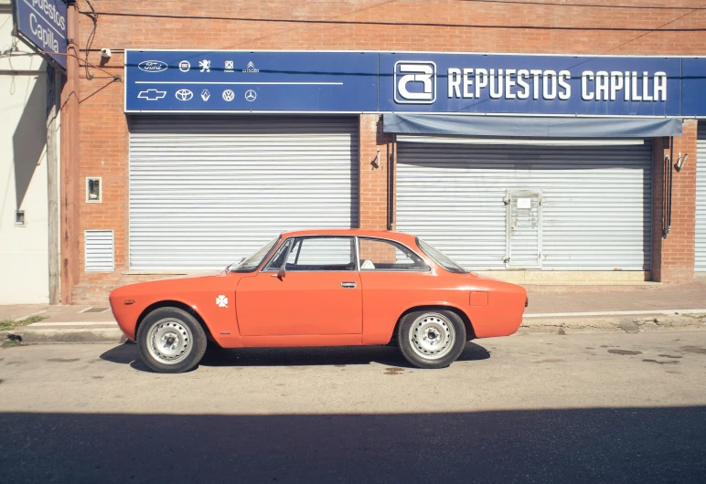 a car parked on the street in front of a store