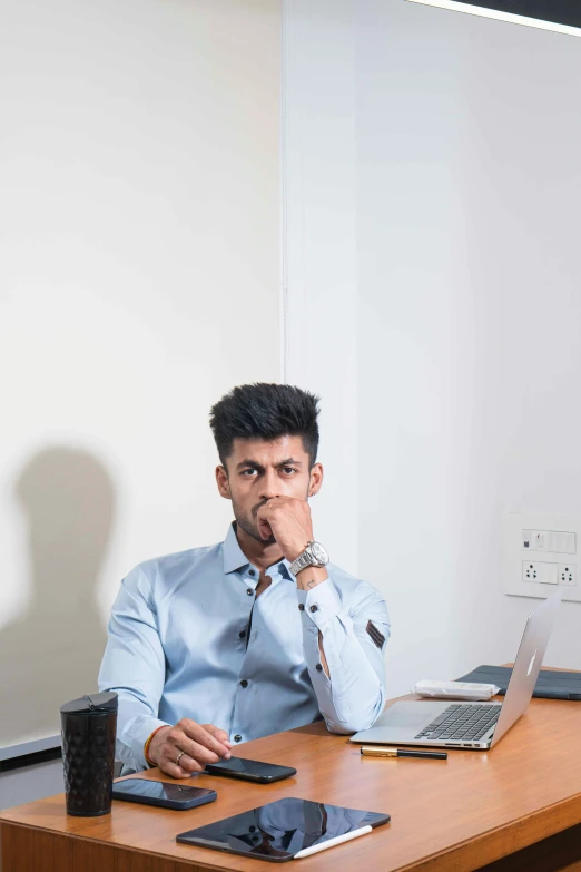 a man with his mouth open next to his computer