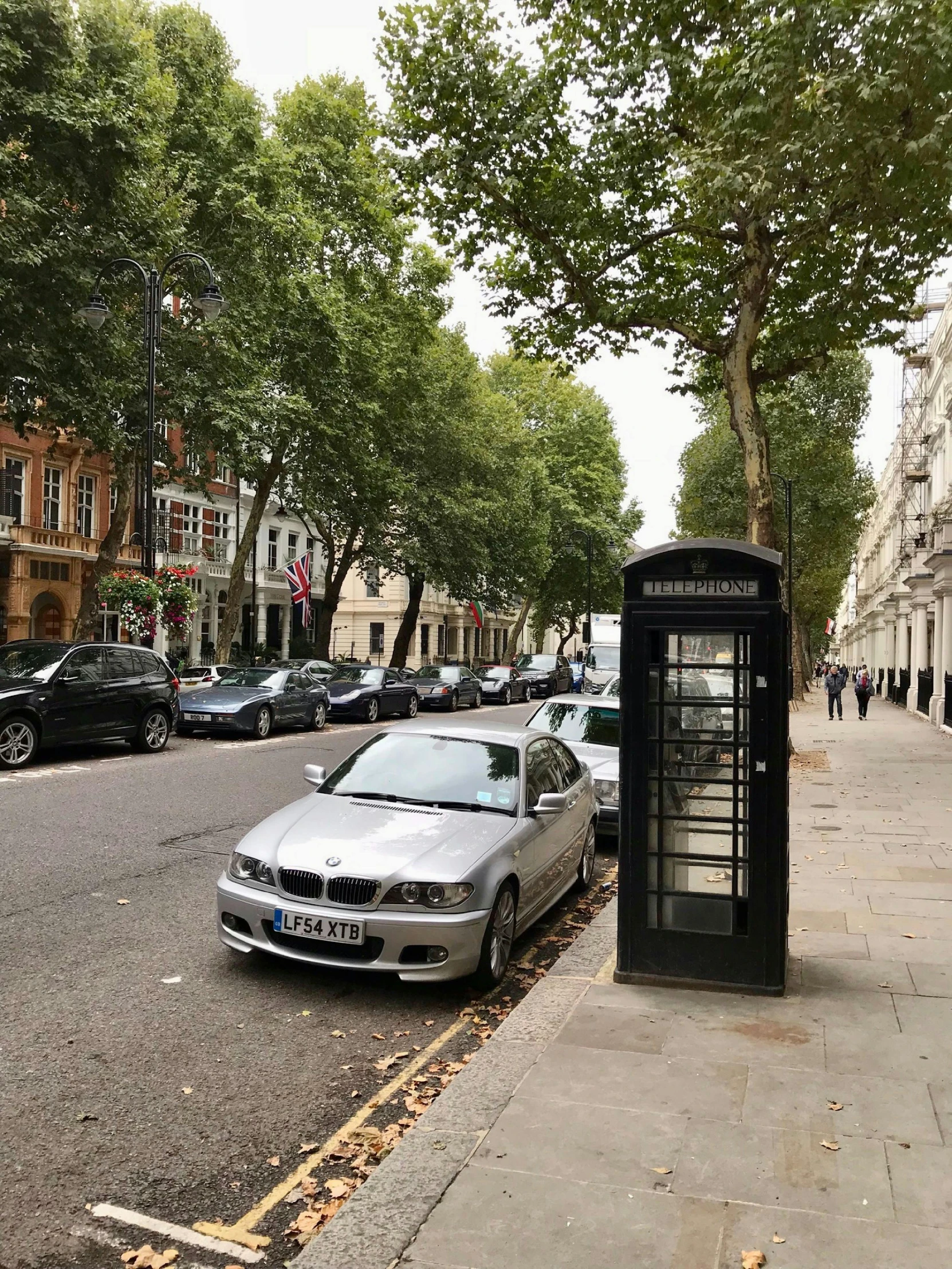 the cars are parked along the street in the city