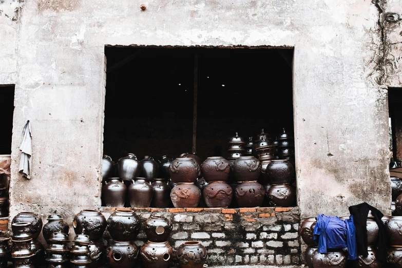 large pots and a blue jacket outside of a building