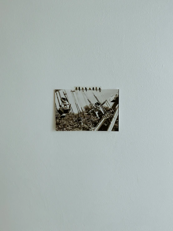 a picture hanging on a wall above another picture