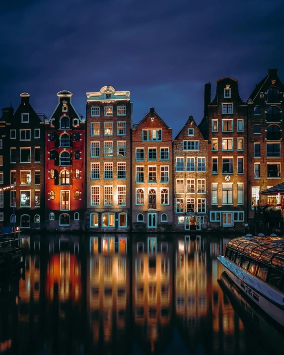 boats sit on a river next to several tall buildings