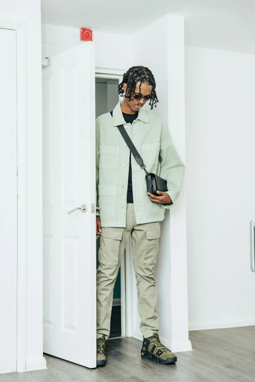 a man standing in front of a doorway holding a camera