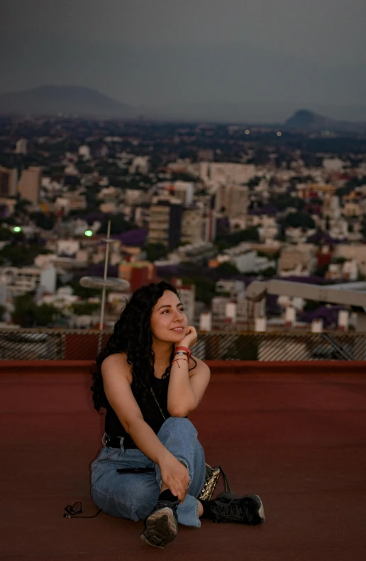 a woman is kneeling and posing on a roof