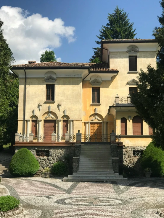 a yellow building with steps leading to it