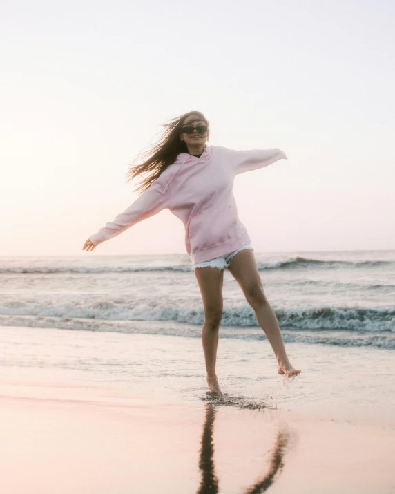 a woman in pink standing on the shore line