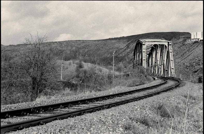 black and white pograph of train crossing over bridge