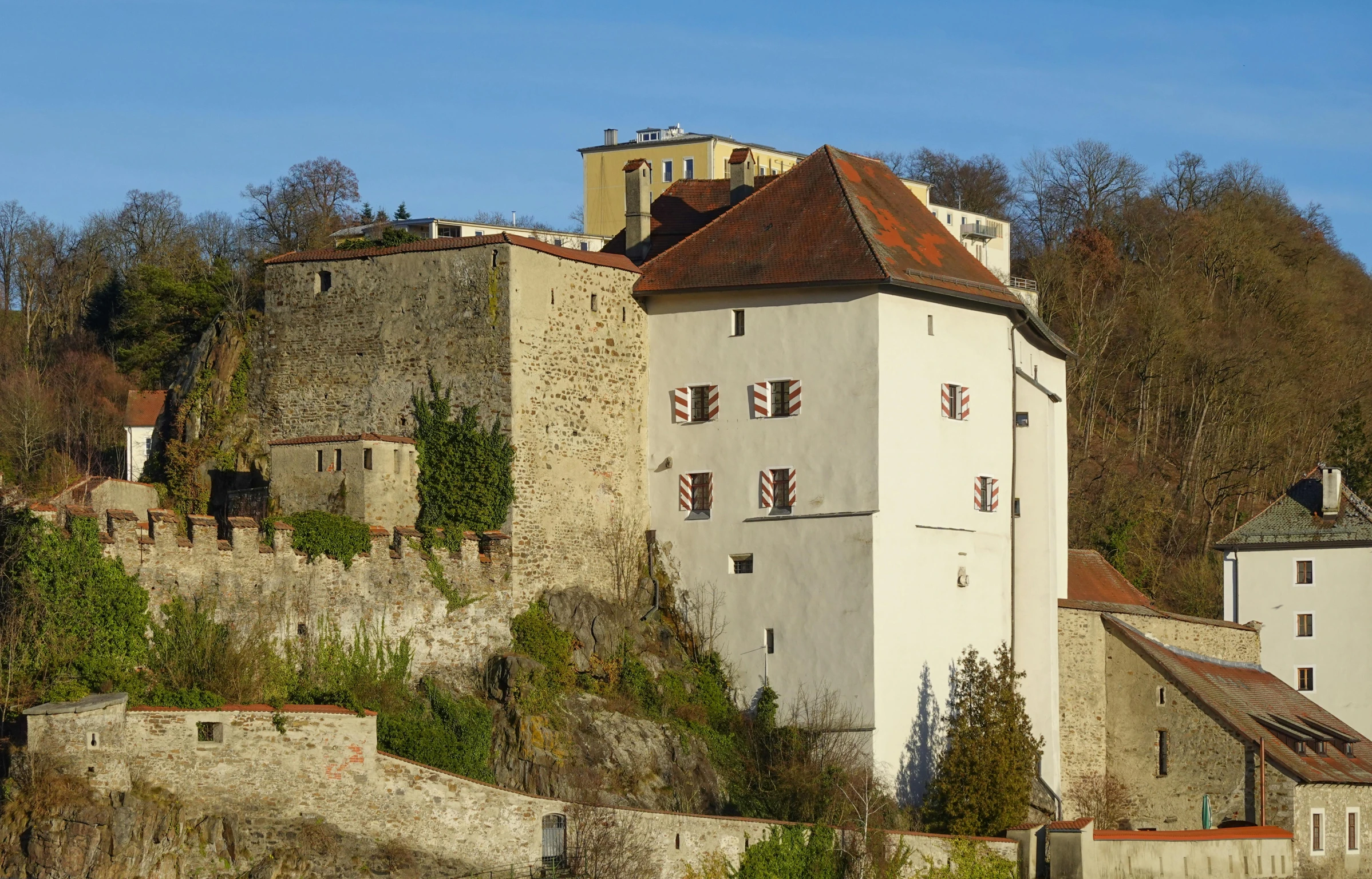 an old castle in the middle of an overgrown hill