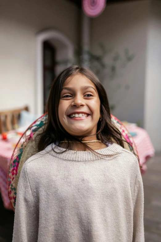 a close up of a child smiling for the camera