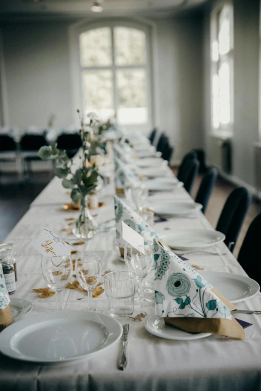 several place settings are set up on a long table