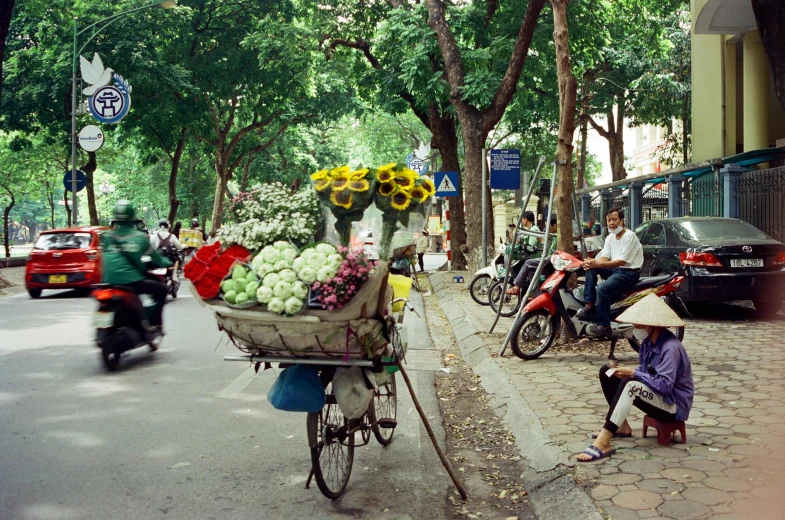 a bunch of fruits and vegetables are laid out in a basket on the street