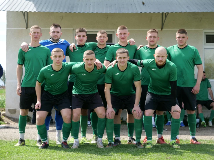 a group of men posing for a soccer team po