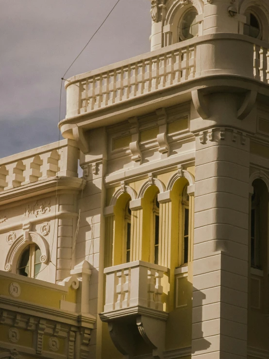 a large tall building with some clocks on top of it