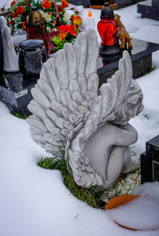 a close up of an angel statue in the snow