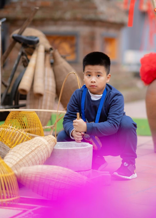 a  sits on the floor next to baskets