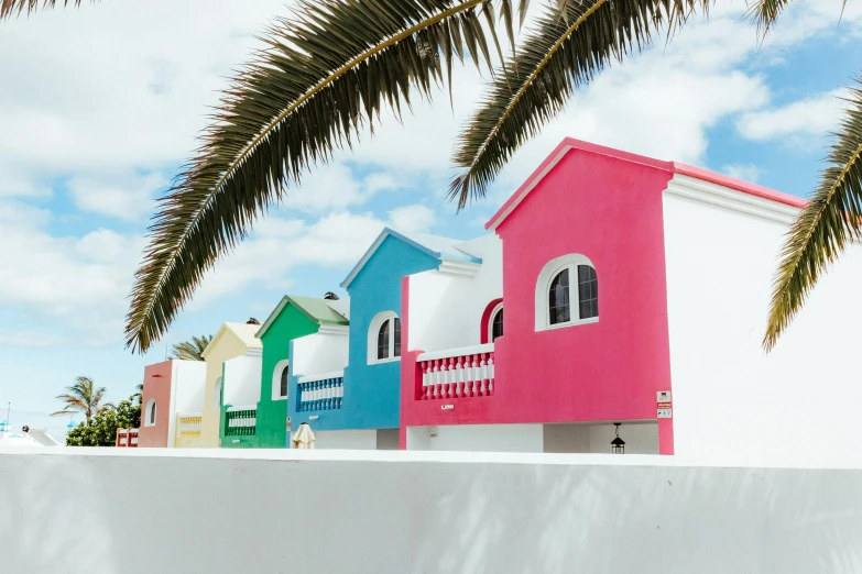 several houses with painted front and back against a blue sky