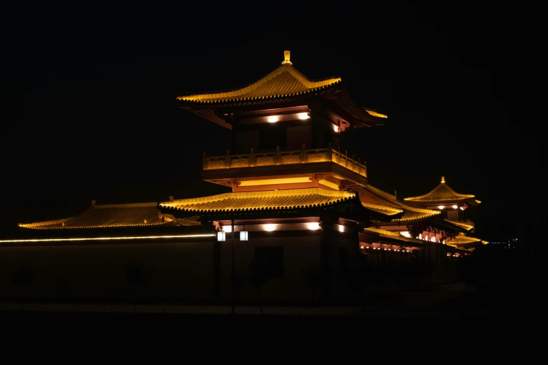 a building at night with many lights on top