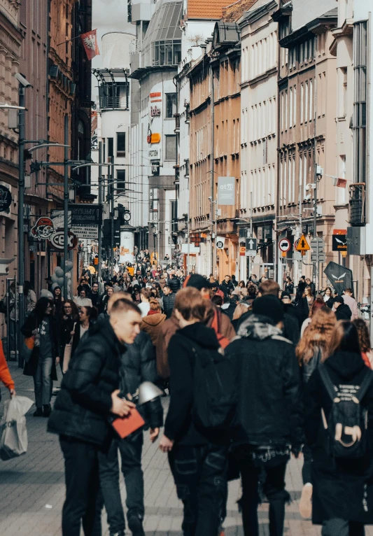 a group of people walking down the middle of a street