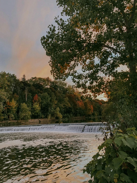 a scene of a river during a sunrise