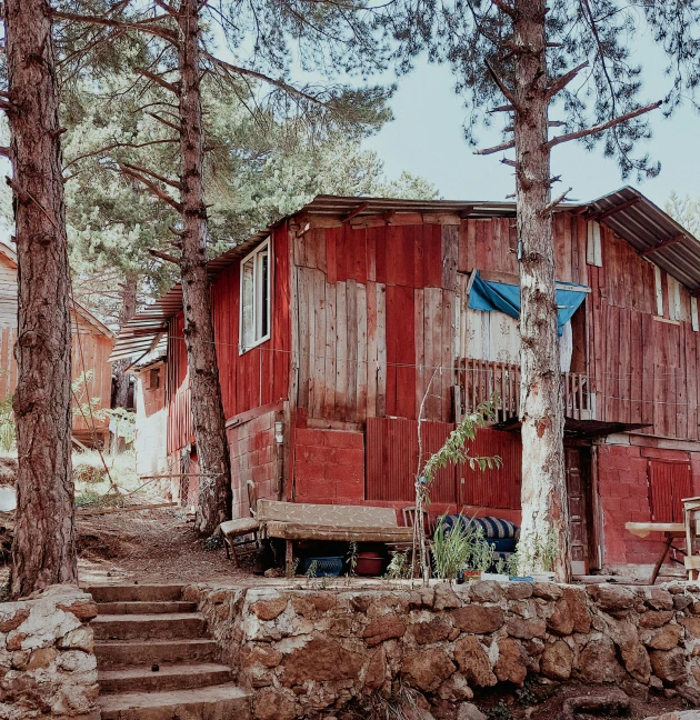 an old red house with a ladder to it