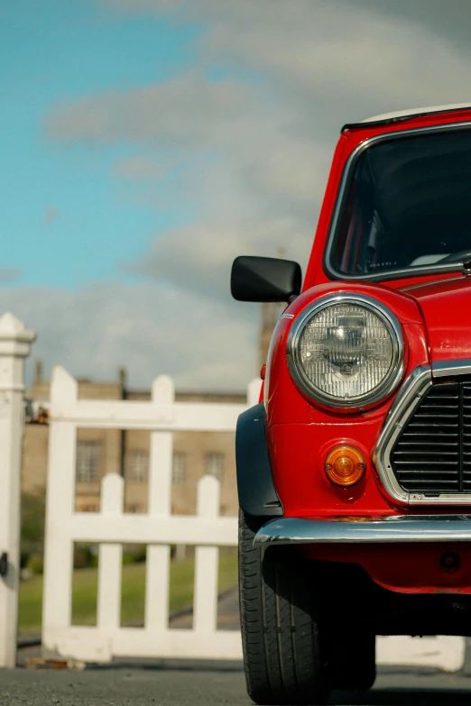 a small red car sits on the street