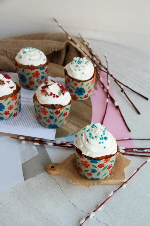 five cupcakes sitting on a plate with colorful sprinkles