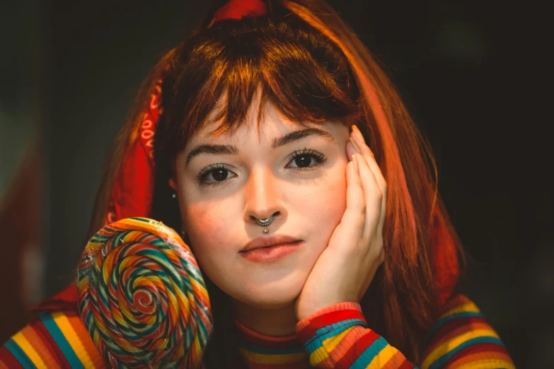 a young woman with a candy lollipop