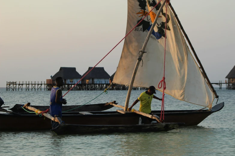 two people in a small boat near a beach