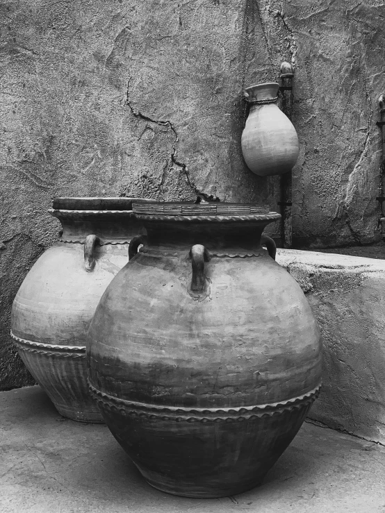 a black and white image of two large vases