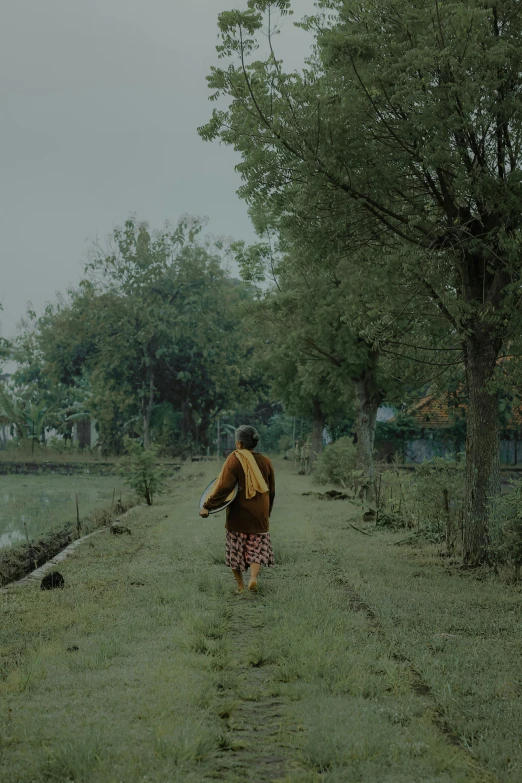 a person walks through the middle of a field