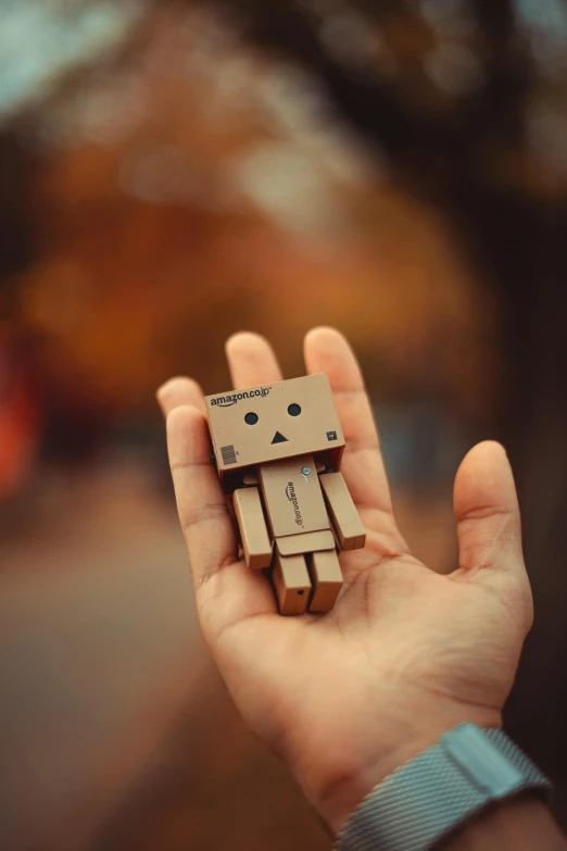 small miniature wooden robot made from wood chips