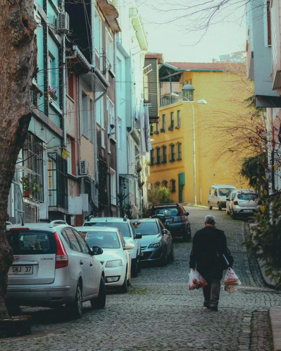 a person walks down a cobble stone street